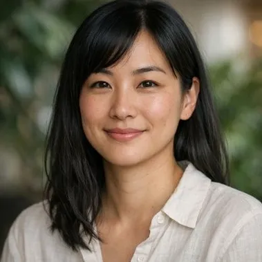 Young Japanese-heritage woman, straight black hair, calm expression, late twenties